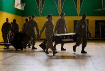 Members of the 35th Medical Group set up an alternate patient care facility at Edgren High School as part of the emergency management exercise at Misawa Air Base, Japan, June 25, 2012. After losing the primary care facility to a simulated fire, the 35 MDG transformed the high school into an alternate treatment facility as they moved all necessary supplies and manpower into position. (U.S. Air Force photo by Staff Sgt. Nathan Lipscomb/Released)