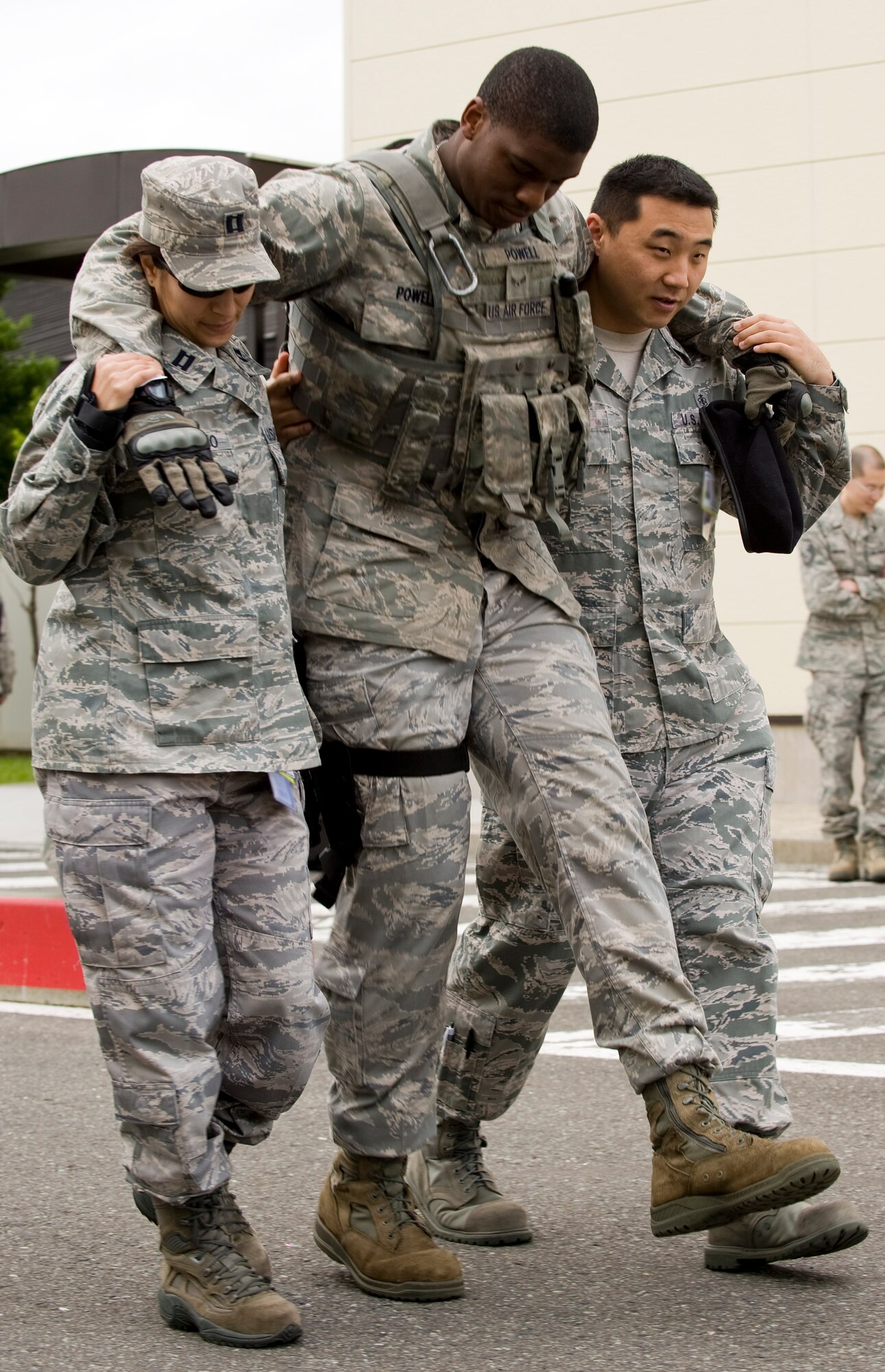 U.S. Air Force Capt. Amalia Solano, left, 35th Medical Group patient care team member, and Staff Sgt. Hyun Cho, right, 35 MDG aerospace medical technician, move simulated patient Airman 1st Class James Powell, 35th Security Forces Squadron member, during an emergency management exercise at Misawa Air Base, Japan, June 25, 2012. The exercise tested the bases’ ability to respond to a natural disaster. (U.S. Air Force photo by Staff Sgt. Nathan Lipscomb/Released)