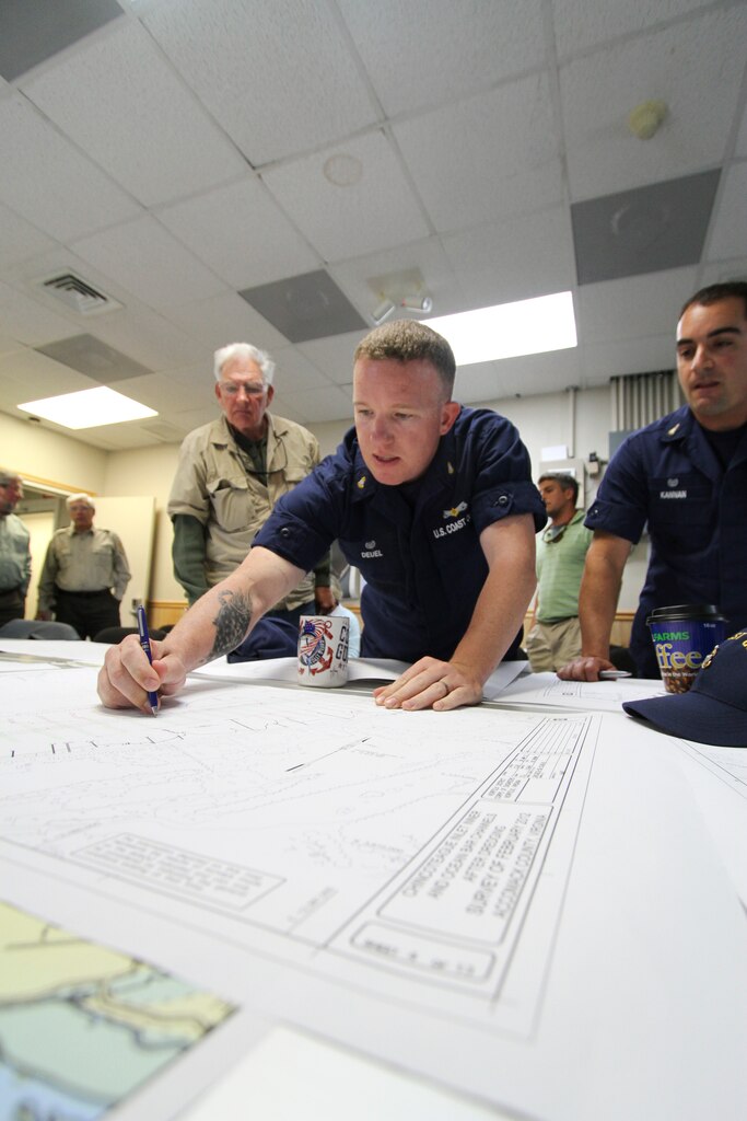 U.S. Coast Guard Chief Petty Officer Aric Deuel, officer in charge of the aids to navigation team Chincoteague, points out where he thinks the new alignment should be for the Chincoteague navigation channel here, May 8, 2012. The new alignment proposal was presented and accepted by members of the Chincoteague navigation partnership, which is comprised of representatives from local government, federal agencies and commercial watermen who rely on the channel for their livelihoods. (U.S. Army photo/Patrick Bloodgood)