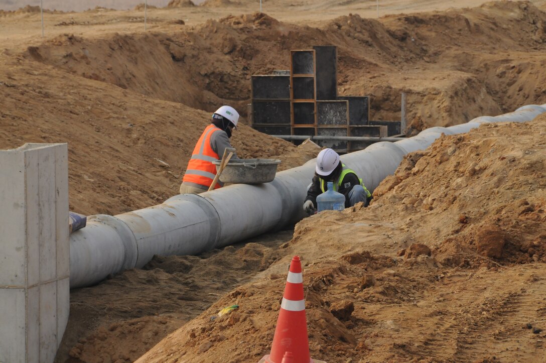 Contractors work on utility pipes at U.S. Army Garrison Humphreys
