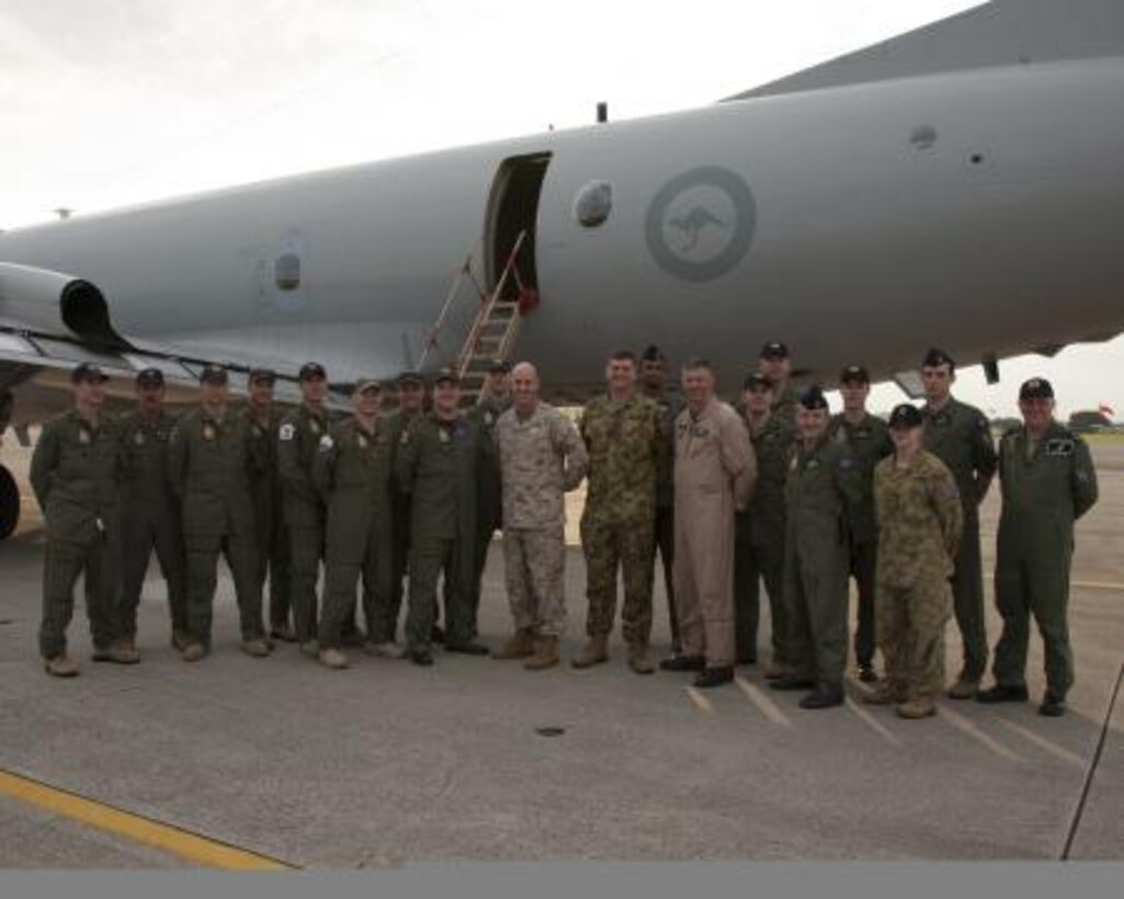 Royal Australian Air Force Group Captain Luke C. Stoodley, U.S. Marine Corps Col. James G. Flynn and Lt Col. Ian S. Wallace, all center, pose for a photo with the crew of a U.N. AP-3C Orion aircraft prior to taking off from Marine Corps Air Station Futenma June 7. The aircraft stopped here to refuel before continuing the bilateral anti-submarine warfare exercise Nichi Gou Trident 2012 between the Japanese Maritime Self-Defense Force and the Australian Defense Force. Stoodley is the commanding officer of U.N. Command (Rear) Yokota Air Base, Japan. Flynn is the commanding officer of MCAS Futenma. Wallace is the executive officer of the air station.