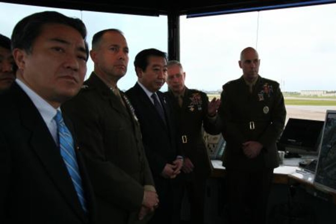 Lt. Gen. Kenneth J. Glueck Jr. (second from right), Maj. Gen. Peter J. Talleri (second from left), and Col. James G. Flynn (right), Marine Corps Air Station Futenma commanding officer, explain the air station’s operations to Prime Minister of Japan Yoshihiko.