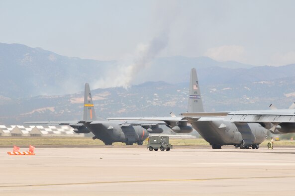 MAFFS equipped C-130's from the 153rd Air Expeditionary Group prepare to take off from Peterson Air Force Base, Colo. June 26, 2012. Crews made 20 drops delivering 52,000 gallons of retardant in an effort to suppress the Waldo Canyon fire. (U.S. Air Force photo/Airman 1st Nichole Grady)