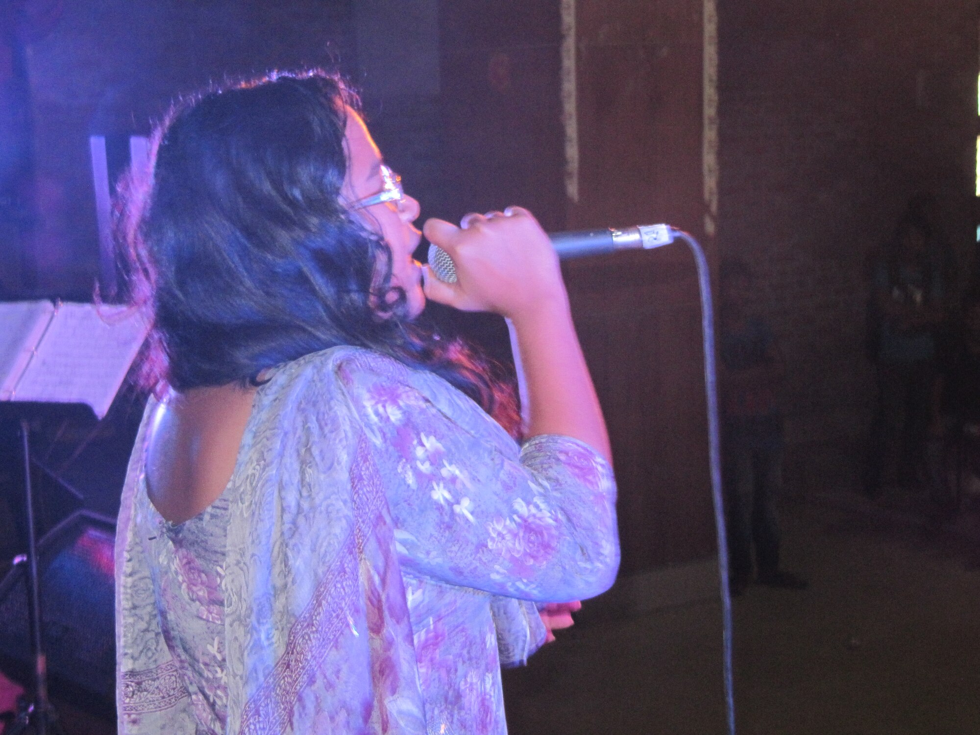 A student from Tejgaon College, Bangladesh sings an a cappella version of a traditional Bangladeshi song during a performance by Final Approach, USAF Band of the Pacific-Asia.