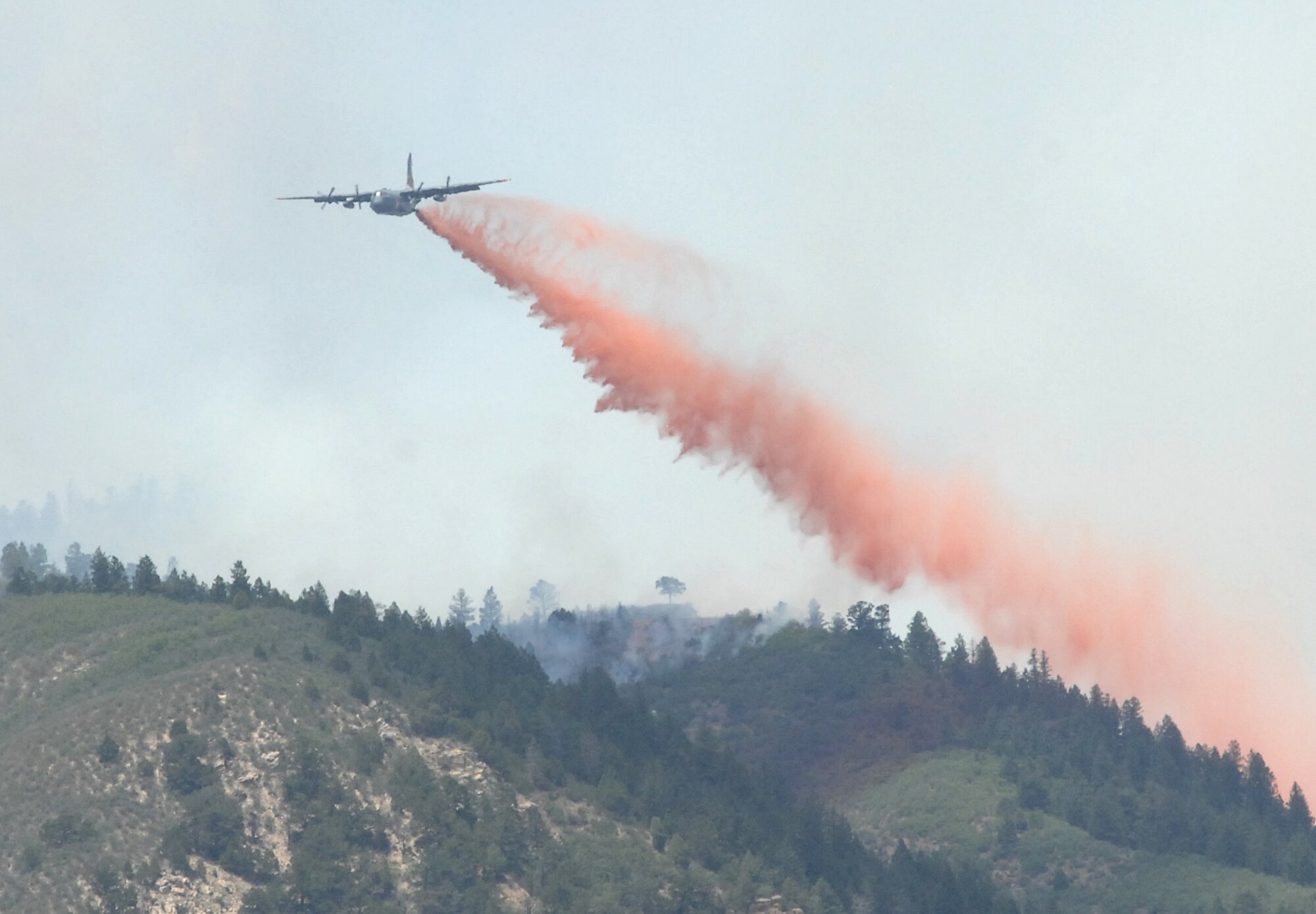 COLORADO SPRINGS, Colo. - A Modular Airborne Fire Fighting System-equipped C-130 drops retardant on a section of the Waldo Canyon fire near Colorado Springs, Colo. June 26. Four MAFFS aircraft from the 302nd and 153rd Airlift Wings are supporting civil authorities as they combat the fire, which has burned since June 23. (U.S. Air Force photo by Tech. Sgt. Thomas J. Doscher)