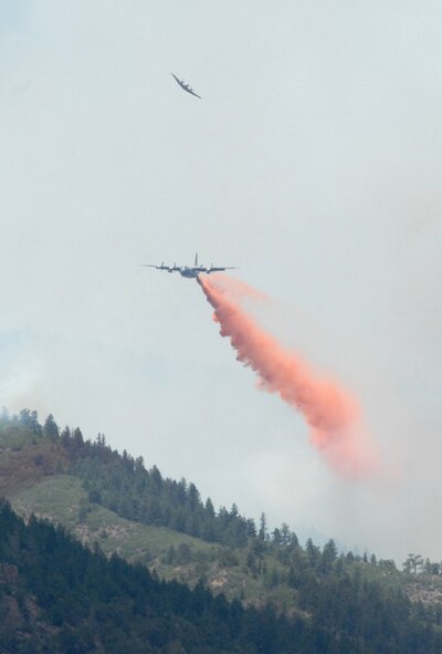 COLORADO SPRINGS, Colo. - A U.S. Forest Service aircraft banks away after leading a Modular Airborne Fire Fighting System-equipped C-130 on a drop run over the Waldo Canyon fire near Colorado Springs, Colo., June 26, 2012. Four MAFFS-equipped aircraft, two from the 302nd Airlift Wing based at Peterson Air Force Base, Colo., and two from the 153rd Airlift Wing of the Wyoming Air National Guard, are supporting wildland fire fighting efforts in the state of Colorado. (U.S. Air Force photo by Capt. Jamie Humphries)