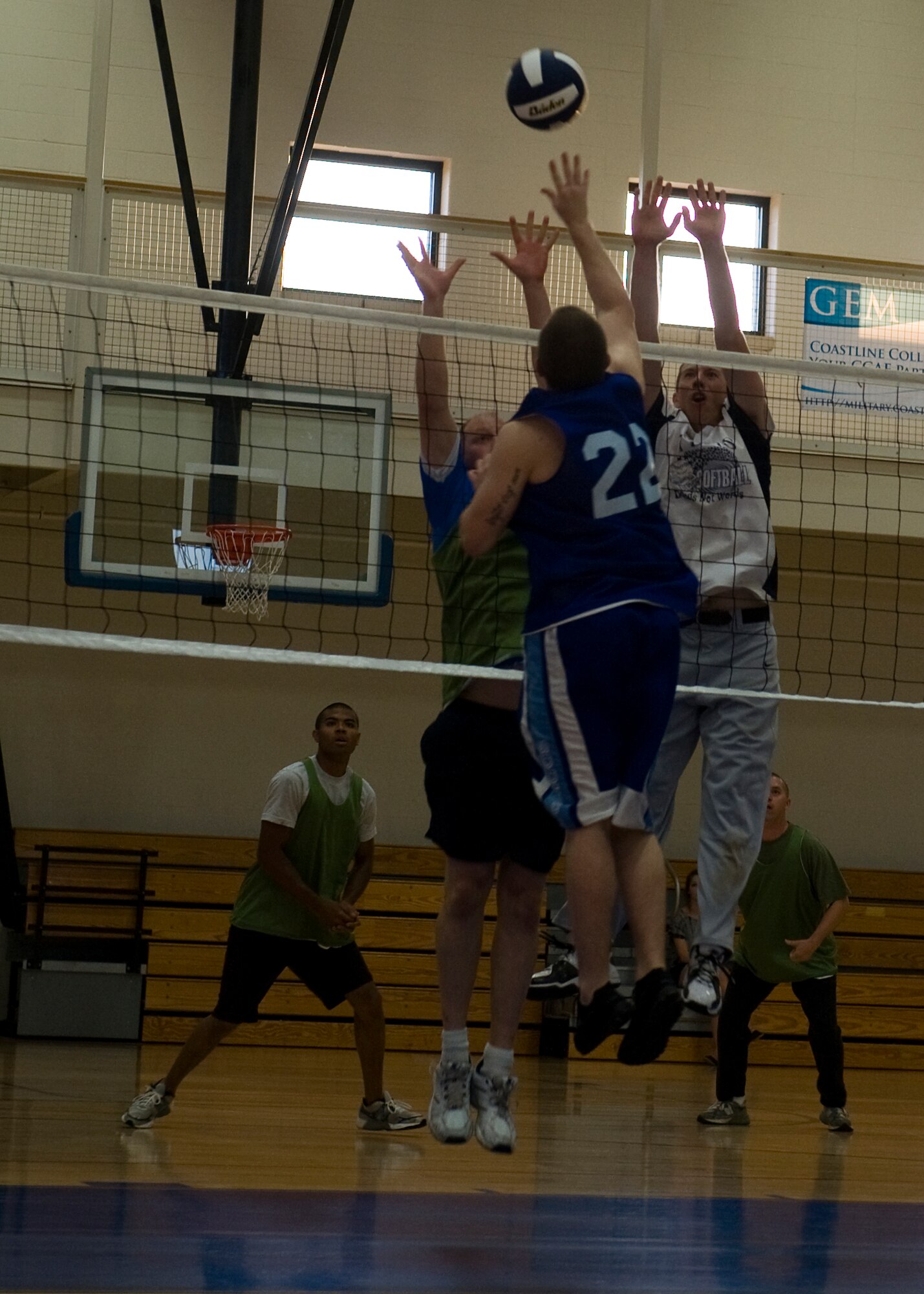 A Dyess airman attempts to hit the volleyball over the net June19, 2012, as members from the 7th Equipment Maintenance Squadron team try to block it at Dyess Air Force Base, Texas. Squadrons throughout Dyess formed teams to participate in the 2012 base volleyball tournament. Regular season games will be played up to July. Afterward, the base volleyball tournament will begin. The tournament will not only determine which squadron is the best, but also give Dyess airmen an opportunity to build moral and promote physical fitness. (U.S. Air Force photo by Airman 1st Class Damon Kasberg/Released) 