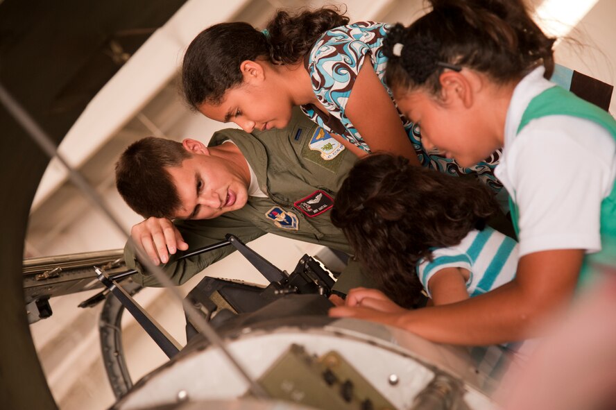 First Lt. Jeff Antal, 47th Operations Support Squadron, shows a group of Girl Scouts the cockpit of a T-6 Texan II at the T-6 Weather Hanger during Scout Aviation Day at Laughlin Air Force Base, Texas, June 22, 2012. The day long camp offered Boy, Girl and Cub Scouts a chance to see Laughlin’s pilot training mission, learn about aviation and discover what makes flight possible. (U.S. Air Force photo/Airman 1st Class Nathan Maysonet)
