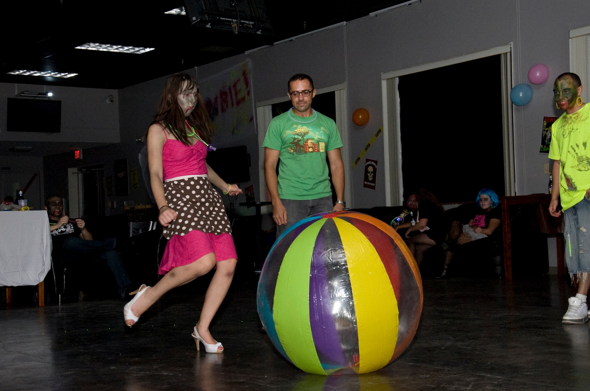 Andy Donahue, wife of U.S. Air Force Staff Sgt. Mark Donahue of the 1st Special Operations Aerospace Medicine Squadron, kicks one of several inflated balls during the Zombie Rave at the Landing Zone Community Center at Hurlburt Field, Fla., June 22, 2012. The event organizers provided beach balls, glow sticks and popular music and videos during the Zombie Rave. (U.S. Air Force photo/Airman 1st Class Benjamin D. Kim)(RELEASED)