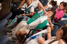 A girl scout tears open her model airplane for a class on flight dynamics at the 86th Flying Training Squadron during Scout Aviation Day at Laughlin Air Force Base, Texas, June 22, 2012. The day long camp offered Boy, Girl and Cub scouts a chance to see Laughlin’s pilot training mission, learn about aviation and discover what makes flight possible. (U.S. Air Force photo/Airman 1st Class Nathan Maysonet)