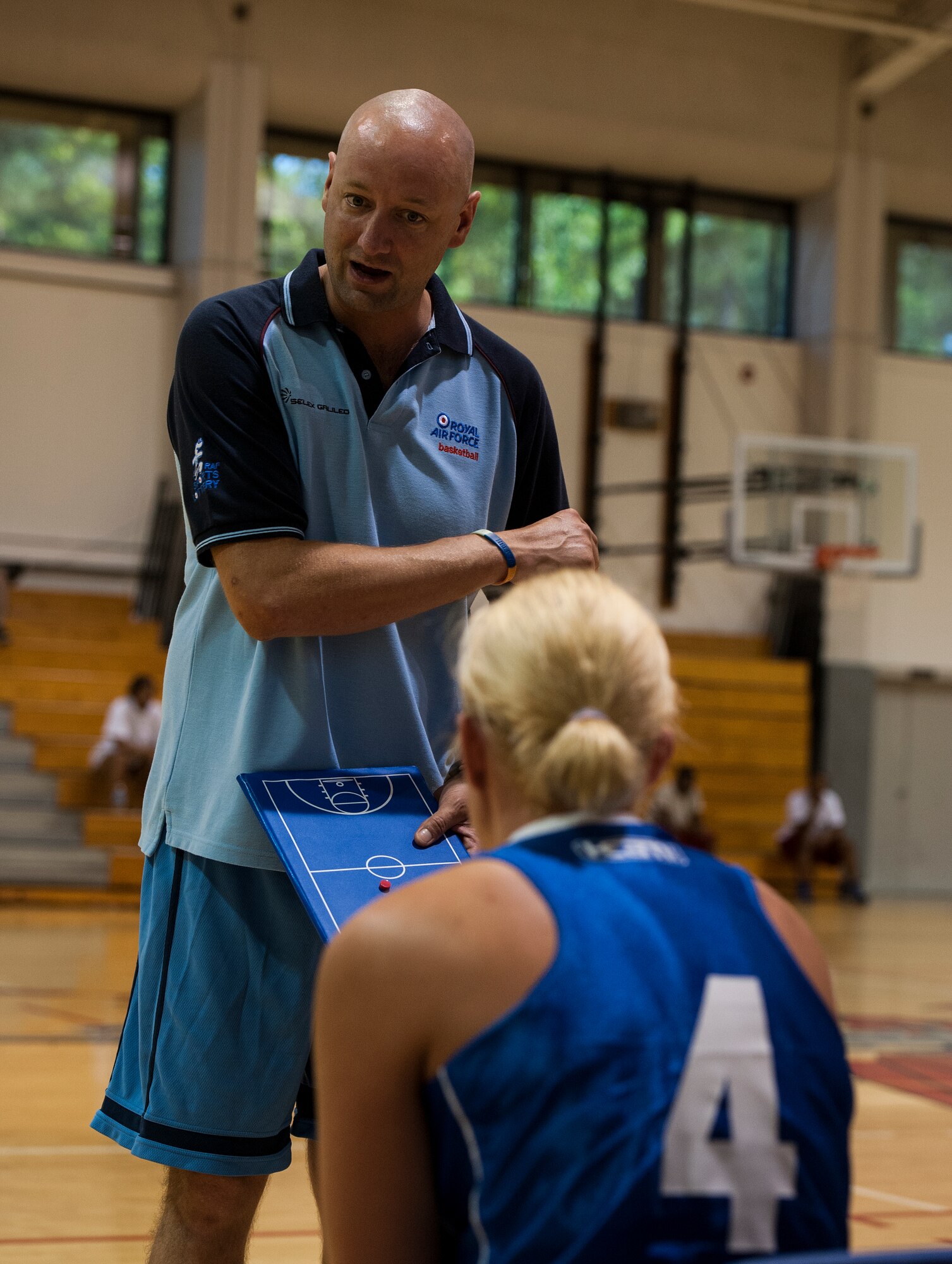 U.K. Royal Air Force Sgt. Mark Reynolds, coach of the women's RAF basketball team, gives a couple of tips and pointers to Cpl. Emma Fare during a scrimmage at the Aderholt Gym on Hurlburt Field, Fla., June 19, 2012. The RAF basketball teams have been coming to Hurlburt Field for a two-week basketball camp for seven years with the exception of last year. (U.S. Air Force photo by Airman 1st Class Christopher Williams) (RELEASED)