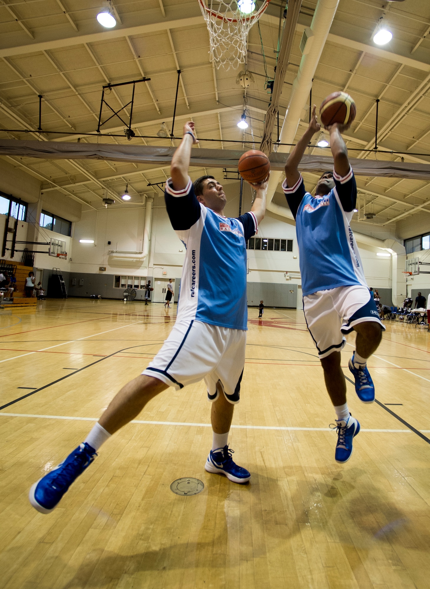 U.K. Royal Air Force lead aircraftsman Warren Birkin (left), a RAF team basketball player, and Sgt. Sunith Defonseka, a RAF team basketball player, warm-up at the Aderholt Gym on Hurlburt Field, Fla., June 20, 2012. Hurlburt Field hosted the RAF during a two-week basketball camp. (U.S. Air Force photo by Airman 1st Class Christopher Williams) (RELEASED)