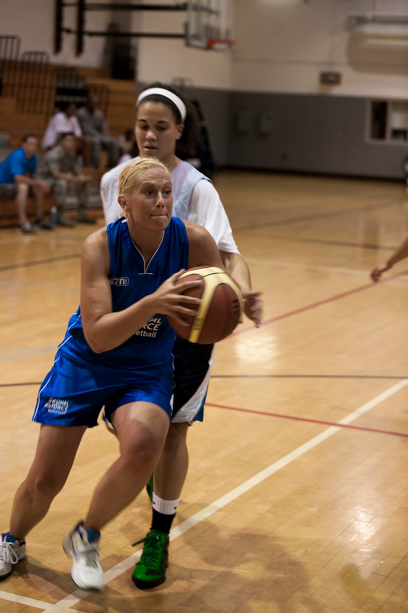 U.K. Royal Air Force Cpl. Emma Fare, a RAF team basketball player, dribbles past a Hurlburt Field defender during a scrimmage at the Aderholt Gym on Hurlburt Field, Fla., June 19, 2012. The RAF women's basketball team had six players with them for the two-week training camp. (U.S. Air Force photo by Airman 1st Class Christopher Williams) (RELEASED)
