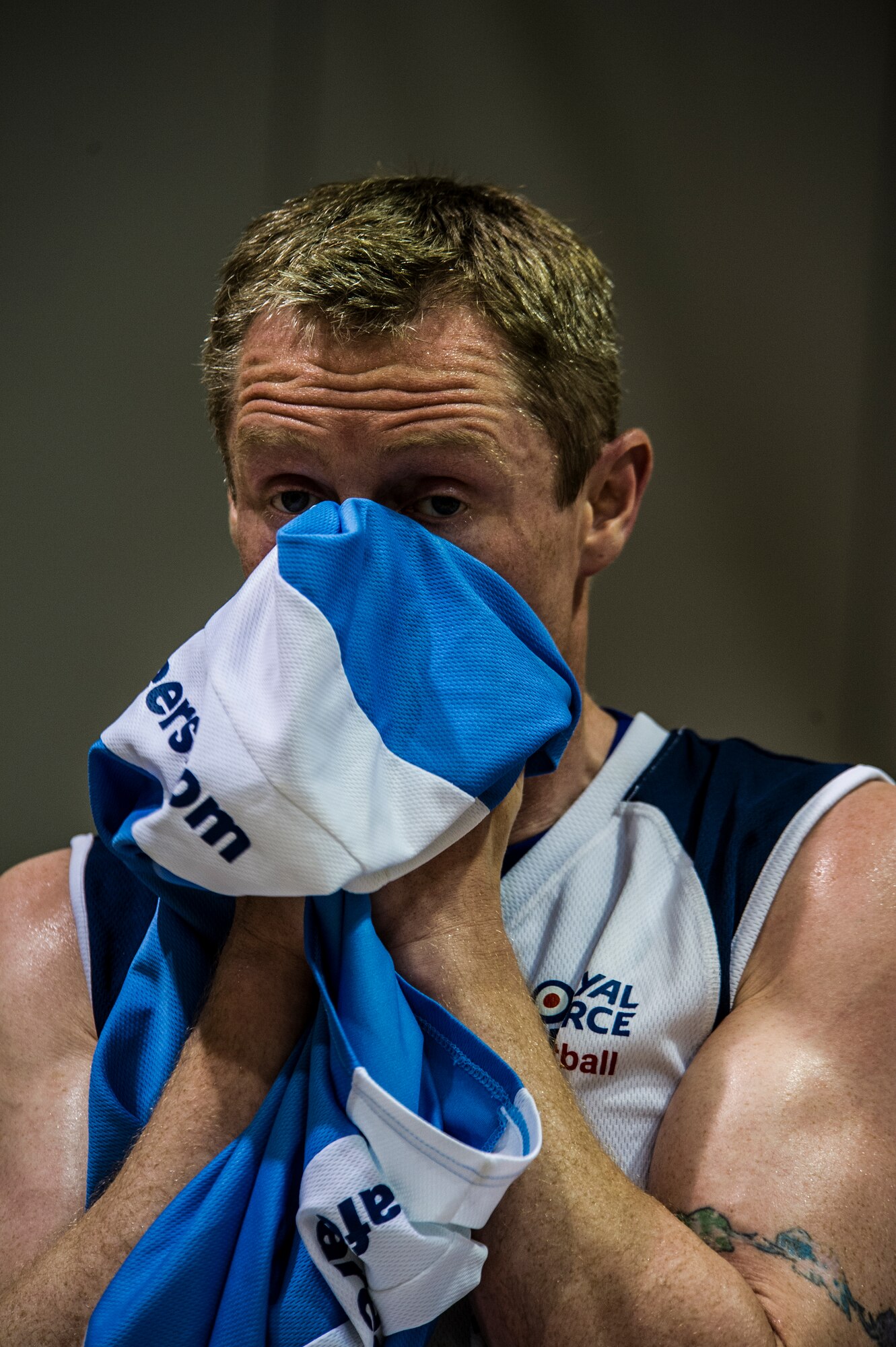 U.K. Royal Air Force Sgt. Gerry Armstrong, a RAF team basketball player, dries his face off during a basketball game between the RAF and Hurlburt Field commandos at the Aderholt Gym on Hurlburt Field, Fla., June 20, 2012. The RAF players were developmental players except for five senior members there as mentors. (U.S. Air Force photo by Airman 1st Class Christopher Williams) (RELEASED)