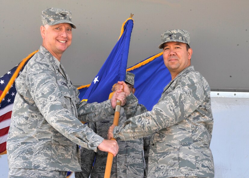 Col. Mark D. Camerer, commander of the 436th Airlift Wing, hands the guidon to Col. Thomas A. Reppart during the 436th Mission Support Group Change of Command Ceremony June 26, 2012, at Dover Air Force Base, Del. Reppart assumed command from Col. Joan A. Garbutt. (U.S. Air Force photo by Tech,. Sgt. Chuck Walker)