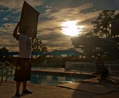 U.S. Air Force Airman 1st Class Brandon Yadon, 723d Aircraft Maintenance Squadron team member gathers cardboard for his team during the First Annual Build a Boat competition at Moody Air Force Base Ga., June 21, 2012. Each team had 45 minutes to build their boats using a box cutter, tape and markers. (U.S. Air Force photo by Airman 1st Class Paul Francis/Released)