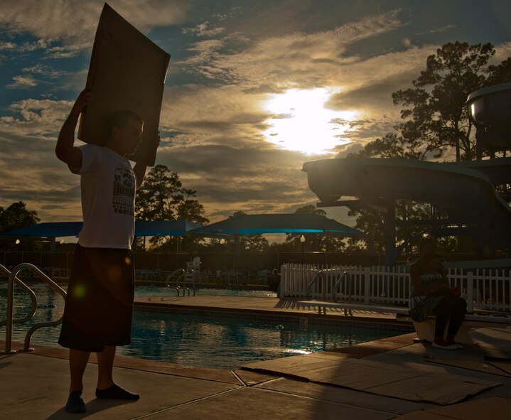 U.S. Air Force Airman 1st Class Brandon Yadon, 723d Aircraft Maintenance Squadron team member gathers cardboard for his team during the First Annual Build a Boat competition at Moody Air Force Base Ga., June 21, 2012. Each team had 45 minutes to build their boats using a box cutter, tape and markers. (U.S. Air Force photo by Airman 1st Class Paul Francis/Released)
