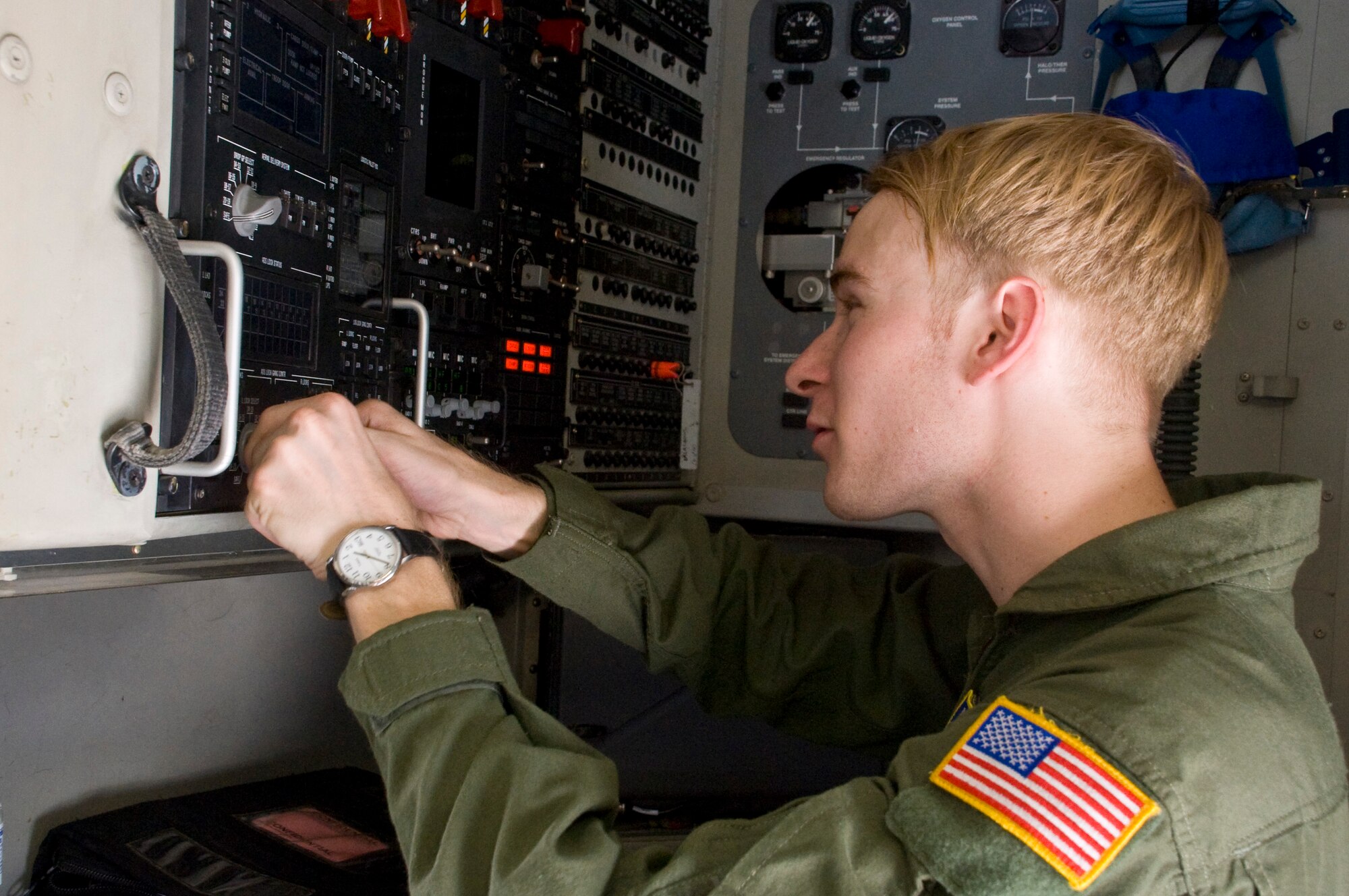 Senior Airman Austin Frazier, a loadmaster with the 3rd Airlift Squadron, demonstrates the capabilities of a cargo control panel inside a C-17 Globemaster III June 22, 2012, at Dover Air Force Base, Del. Loadmasters ensure that cargo is secure and properly packed before take-off and properly unloaded upon landing. (U.S. Air Force photo by Senior Airman Matthew Hubby)