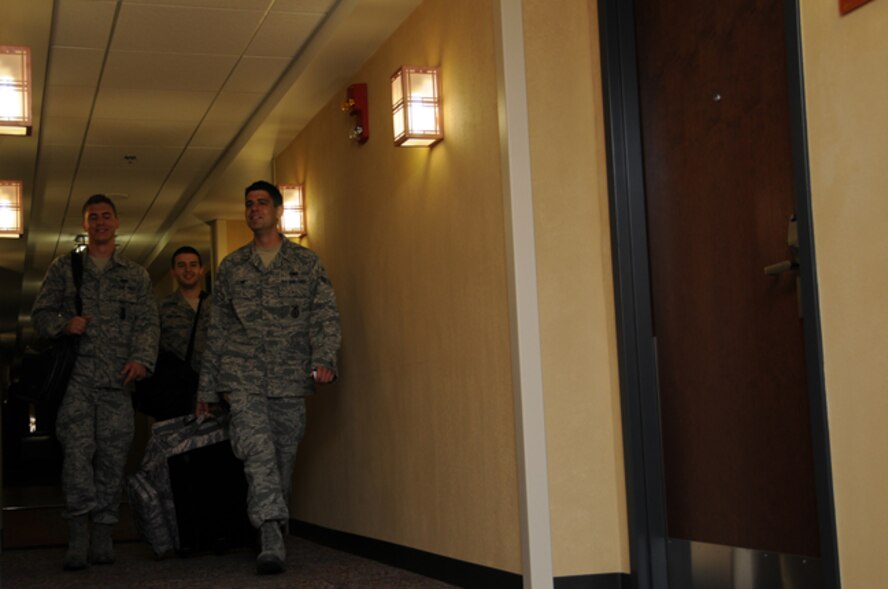 Members of the 911th Security Forces Squadron carry bags through the new lodging building at the 911th Airlift Wing, June 3, 2012. This is the first unit training assembly weekend that the lodging building is open for use. The new $8.5 million facility, which has 50 rooms to accommodate military members, DoD Civilian and contractors, was recently nominated for a Gold LEED (Leadership in Energy and Environmental Design) rating for being designed using strategies aimed at improving performance in energy savings, water efficiency and improved indoor environment quality.  (U.S. Air Force photo by Senior Airman Joshua J. Seybert/Released)