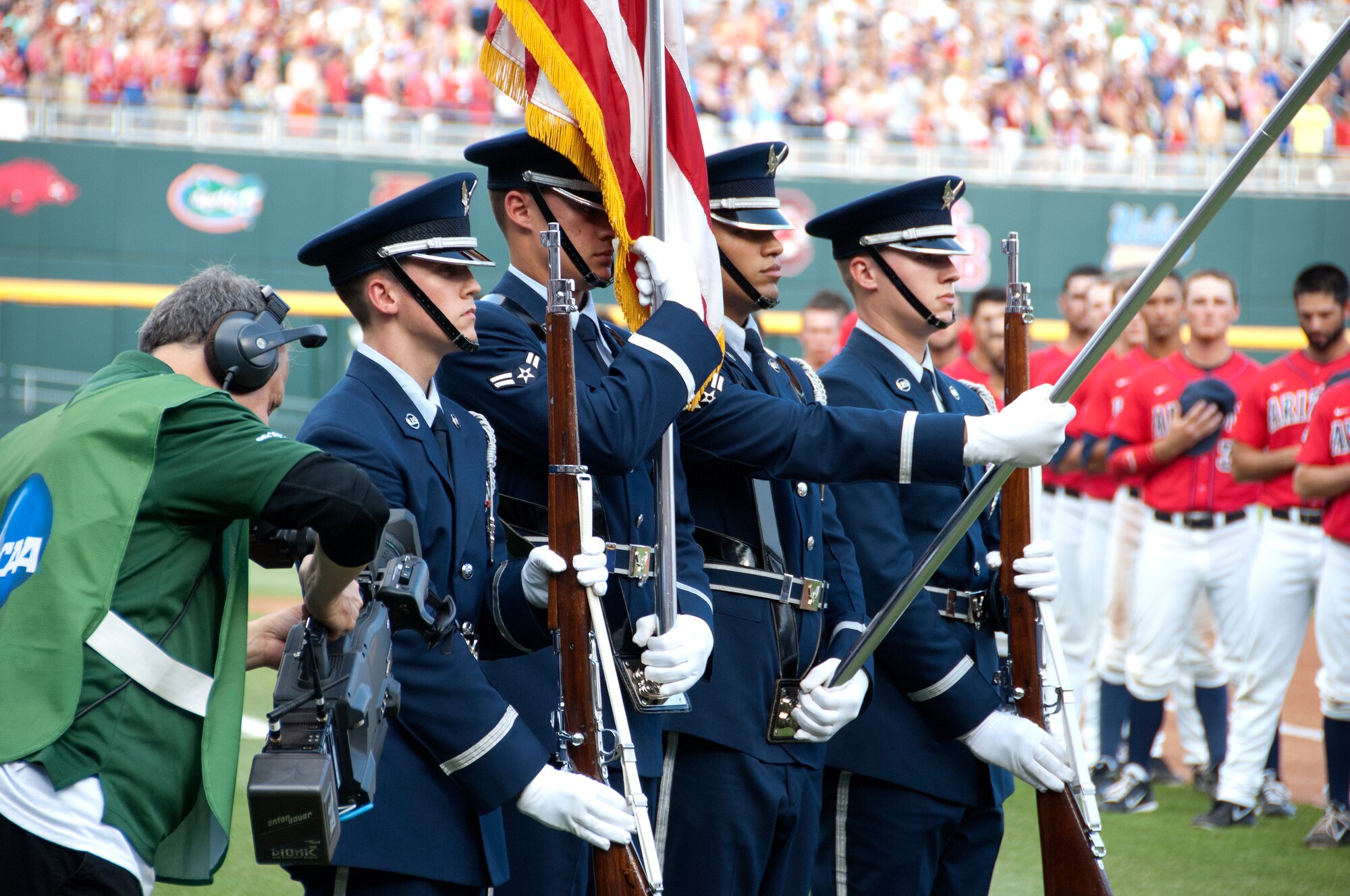 (Left to Right) U.S. Airman 1st Class Troy Humphries, Airman 1st Class Jurgen Kuse, Airman 1st Class Pablo Acededo and Airman 1st Class Tyler Fields, who are members of the Offutt AFB Honor Guard, present the colors during the National Anthem prior to game one of the 2012 College World Series championship series at TD Ameritrade Park in downtown Omaha, Neb., June 24. The University of Arizona went on to defeat the University of South Carolina with a score of 5 -1 in game one of the best of three series. (U.S. Air Force photo by Delanie Stafford/Released)