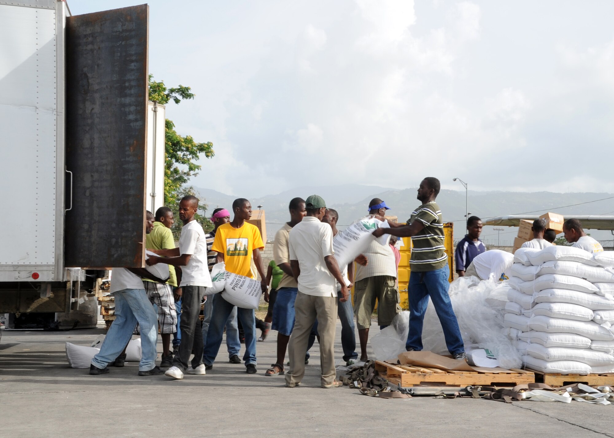 PORT-AU-PRINCE, Haiti – Haitian citizens load a truck with food and medical supplies on the Toussaint Louverture International Airport flightline, June 22, 2012. Fifty thousand pounds of food and medical supplies were delivered by an Altus Air Force Base aircrew to support the Mission Lifeline in Haiti, which cares for 11,000 men, women, and children. (U.S. Air Force photo by Airman 1st Class Franklin R. Ramos / 97th Air Mobility Wing / Released)