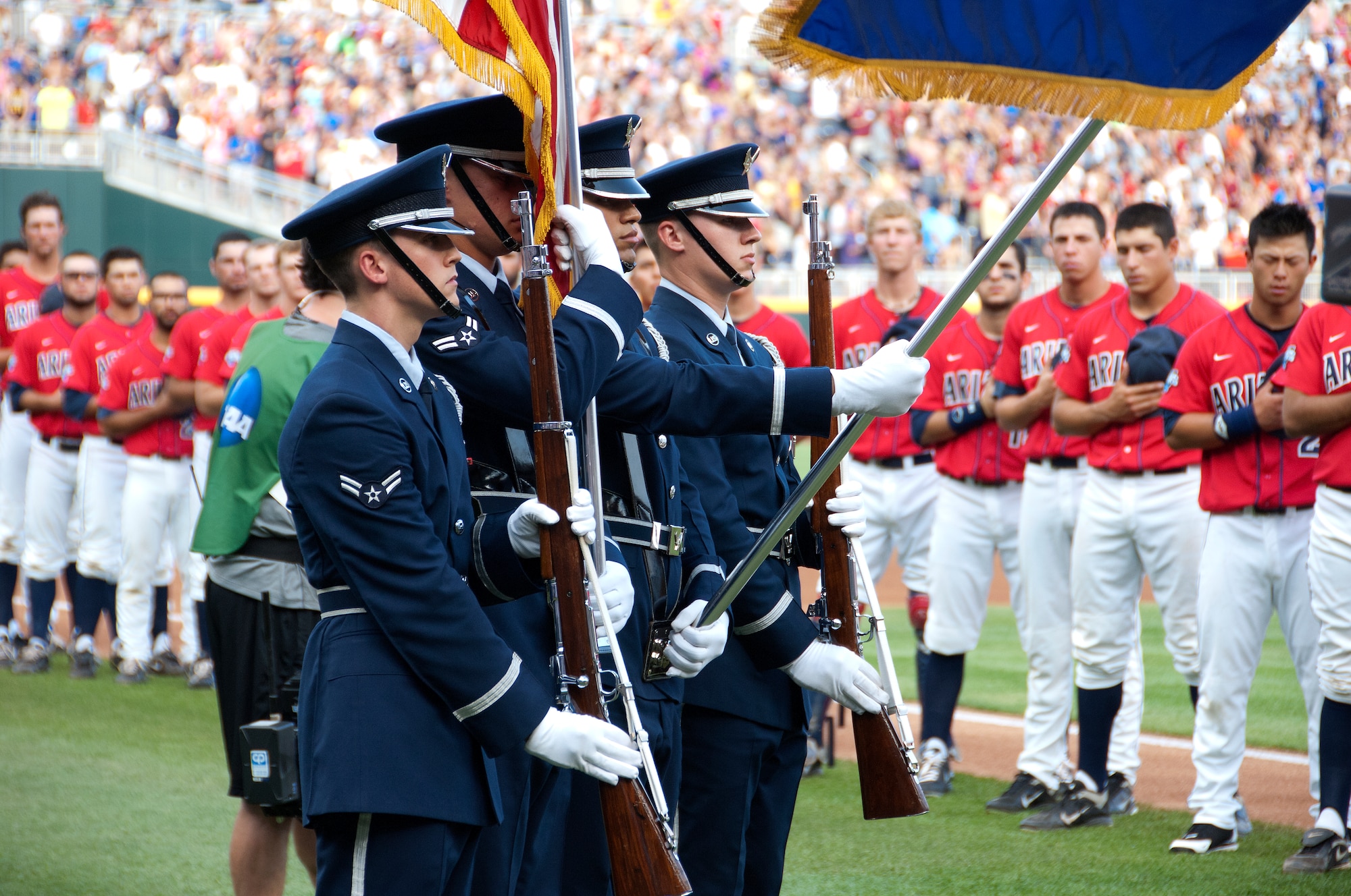 (Left to Right) U.S. Air Force Airman 1st Class Troy Humphries, Airman 1st Class Jurgen Kuse, Airman 1st Class Pablo Acededo and Airman 1st Class Tyler Fields, who are members of the Offutt AFB Honor Guard, present the colors during the National Anthem prior to game one of the 2012 College World Series championship series at TD Ameritrade Park in downtown Omaha, Neb., June 24. The University of Arizona played and defeated the University of South Carolina in game one of the best of three series. (U.S. Air Force photo by Delanie Stafford/Released)