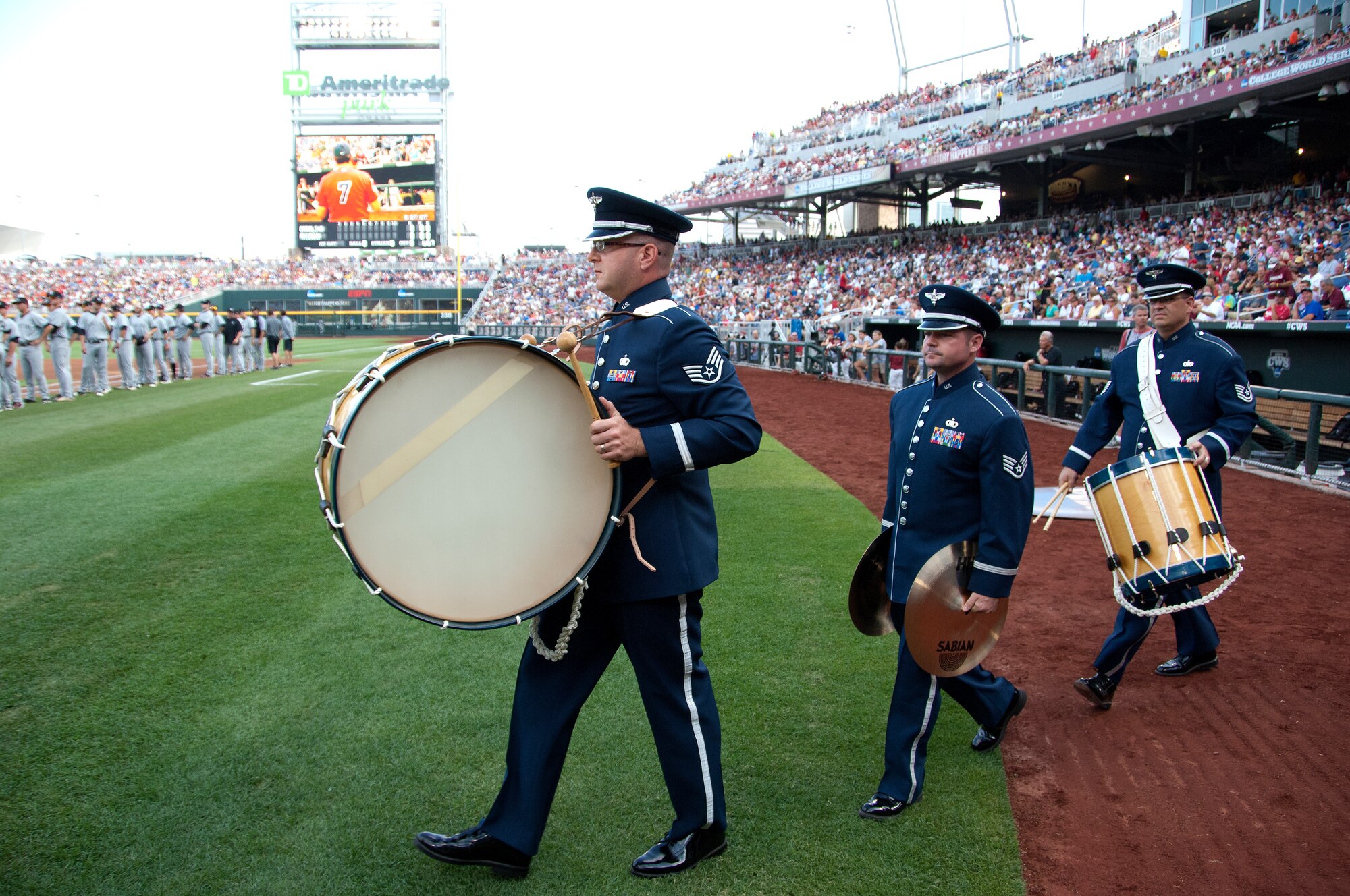 (Left to Right) U.S. Air Force Staff Sgt. Jarett Robinett, Staff Sgt. Dan Bragdon and Tech. Sgt. James Mangette from the Heartland of America Band based at Offutt AFB, Neb., take the field prior to performing the National Anthem for game one of the 2012 College World Series championship at TD Ameritrade Park in downtown Omaha, Neb., June 24. Game one of this best of three series, had the University of Arizona playing the University of South Carolina.  (U.S. Air Force photo by Delanie Stafford/Released)