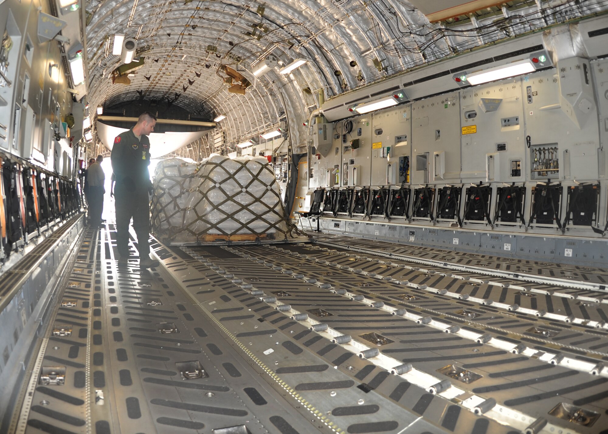 ALTUS AIR FORCE BASE, Okla. – Staff Sgt. William Morgan, 58th Airlift Squadron formal training unit instructor loadmaster, inspects a pallet of split beans on a C-17 Globemaster III as part of a delivery to Haiti, June 22, 2012. The Denton Amendment allows for the Department of Defense to transport privately-donated humanitarian cargo to foreign countries using military aircraft on a space available basis. (U.S. Air Force photo by Airman 1st Class Franklin R. Ramos / 97th Air Mobility Wing / Released)
