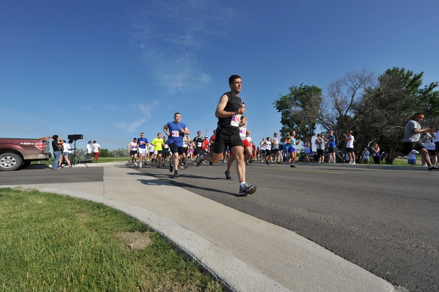MINOT AIR FORCE BASE, N.D. -- Participants take off during the Air Force Global Strike Command Striker Life Half Marathon here. The first-ever command-wide half marathon series started this spring and will end this summer. This event is part of an effort to promote physical fitness and encourage goal-setting by Airmen.  (U.S. Air Force photo/Senior Airman Brittany Y. Auld)