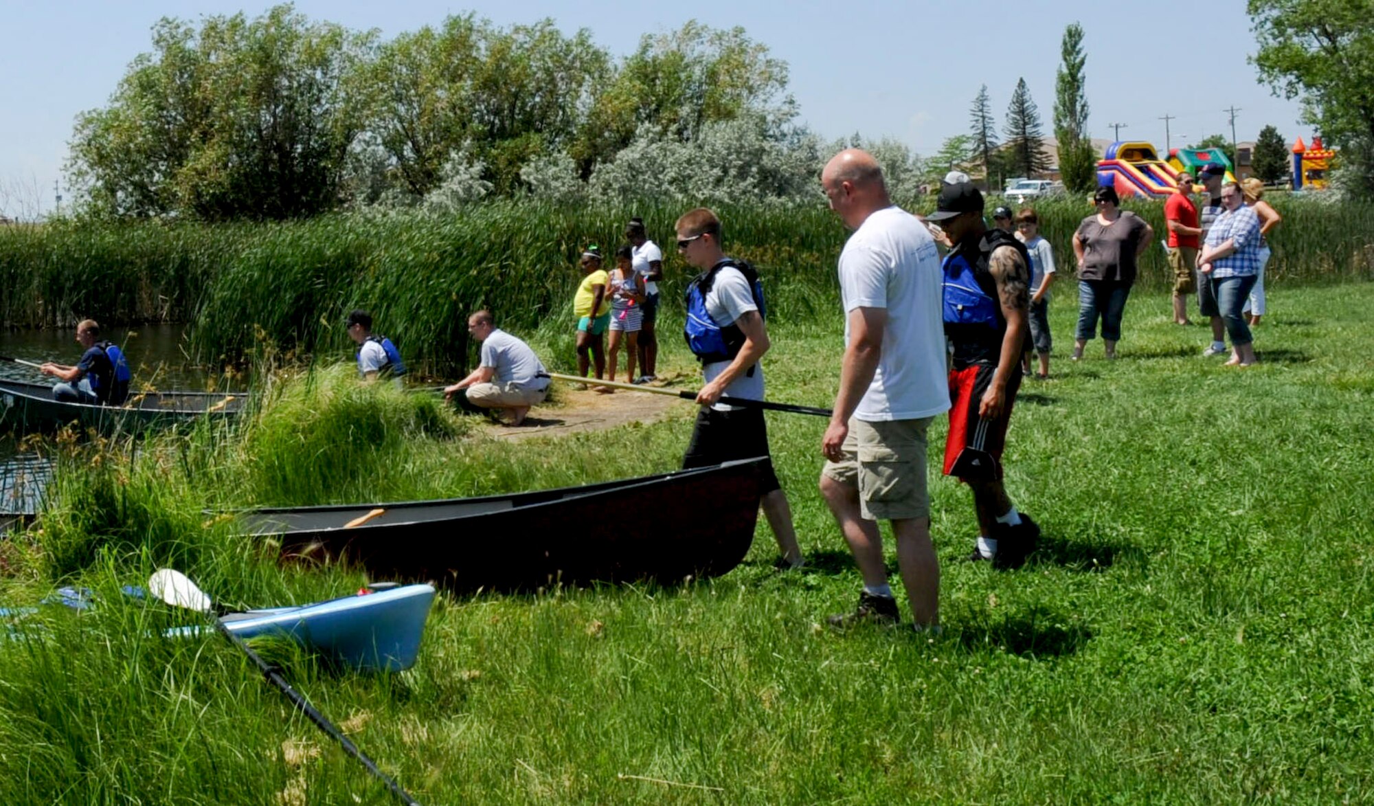 Canoe race contestants board their vessels at the start of the canoe races during the 28th Force Support Squadron “When Nature Calls” event at Heritage Lake Park on Ellsworth Air Force Base, S.D., June 23, 2012. The canoe race was one of many activities designed to get people outside and enjoying the outdoors. (U.S. Air Force photo by Airman 1st Class Anania Tekurio/Released) 