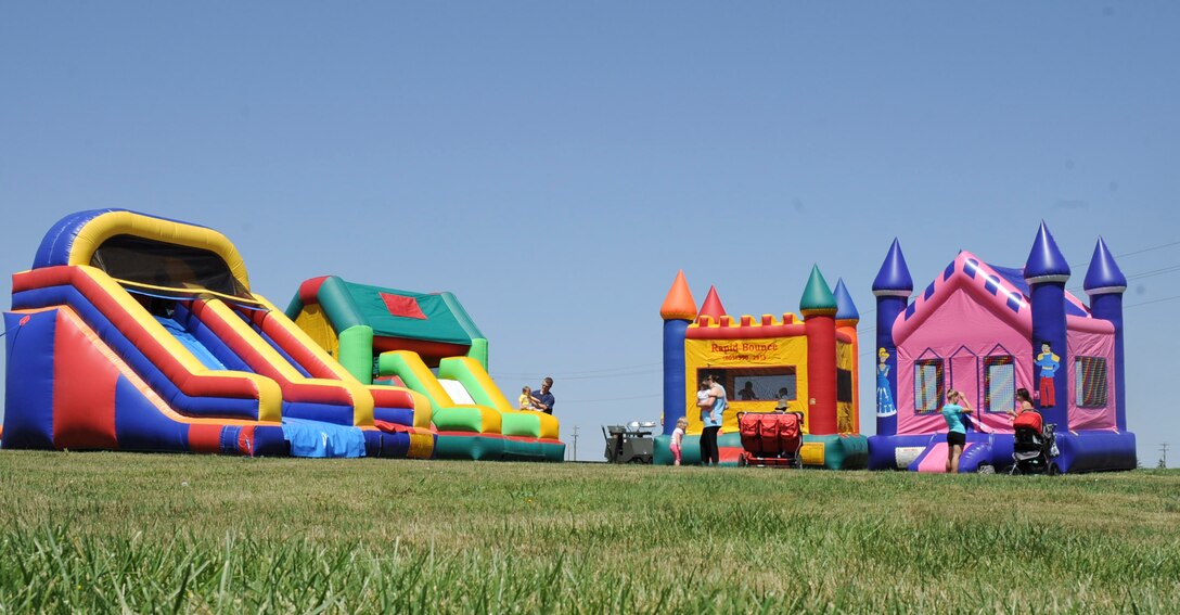 Inflatable jumping castles and slides were set up for people attending the 28th Force Support Squadron “When Nature Calls” event at Heritage Lake Park on Ellsworth Air Force Base, S.D., June 23, 2012. The event, designed to get people outside and enjoy the outdoors, also consisted of a session of yoga, a 5k fun run, a fishing derby and a canoe race. (U.S. Air Force photo by Airman 1st Class Anania Tekurio/Released) 