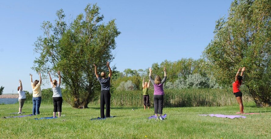 Jillian Anawaty, yoga instructor from Rapid City, leads a group of yoga enthusiasts during the 28th Force Support Squadron’s “When Nature Calls” event at Heritage Lake Park on Ellsworth Air Force Base, S.D., June 23, 2012. The event, which along with the yoga class, featured a 5k run, a fishing derby, bouncy castles and canoe races, was designed to encourage people to get outside and enjoy the great outdoors. (U.S. Air Force photo by Airman 1st Class Anania Tekurio/Released) 