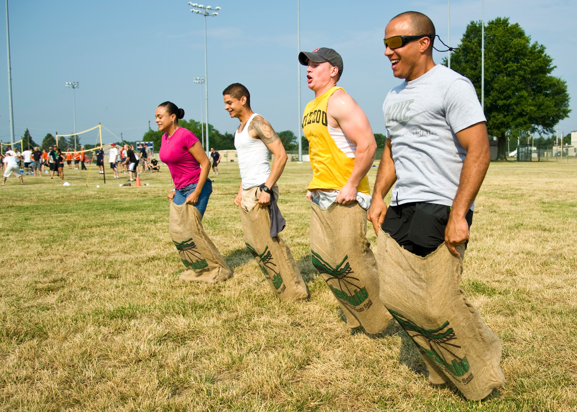 Members of the 436th Mission Support Group compete in a sack-race during a group-wide sports day June 22, 2012, at Dover Air Force Base, Del. Sports day was held in conjunction with Power Reduction Day to get service members out of the office and reduce energy consumption. (U.S. Air Force photo by Airman 1st Class Samuel Taylor)

