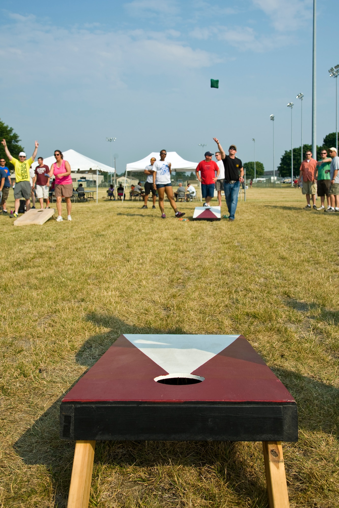 Members of the 436th Mission Support Group play corn-hole during a group-wide sports day June 22, 2012, at Dover Air Force Base, Del. Sports day was held in conjunction with Power Reduction Day to get service members out of the office and reduce energy consumption. (U.S. Air Force photo by Airman 1st Class Samuel Taylor)

