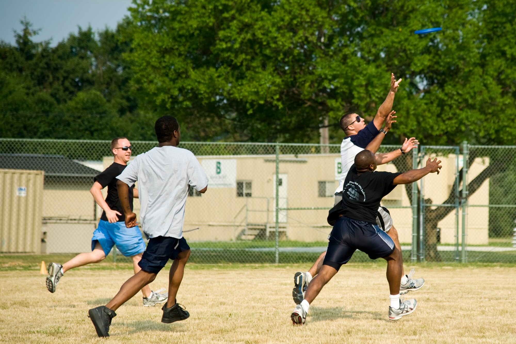 Members of the 436th Mission Support Group play Ultimate Frisbee during a group-wide sports day June 22, 2012, at Dover Air Force Base, Del. Sports day was held in conjunction with Power Reduction Day to get service members out of the office and reduce energy consumption. (U.S. Air Force photo by Airman 1st Class Samuel Taylor)

