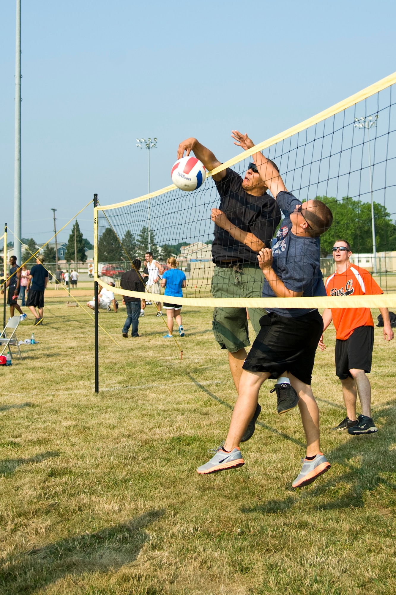 Members of the 436th Mission Support Group play volleyball during a group-wide sports day June 22, 2012, at Dover Air Force Base, Del. Sports day was held in conjunction with Power Reduction Day to get service members out of the office and reduce energy consumption. (U.S. Air Force photo by Airman 1st Class Samuel Taylor)