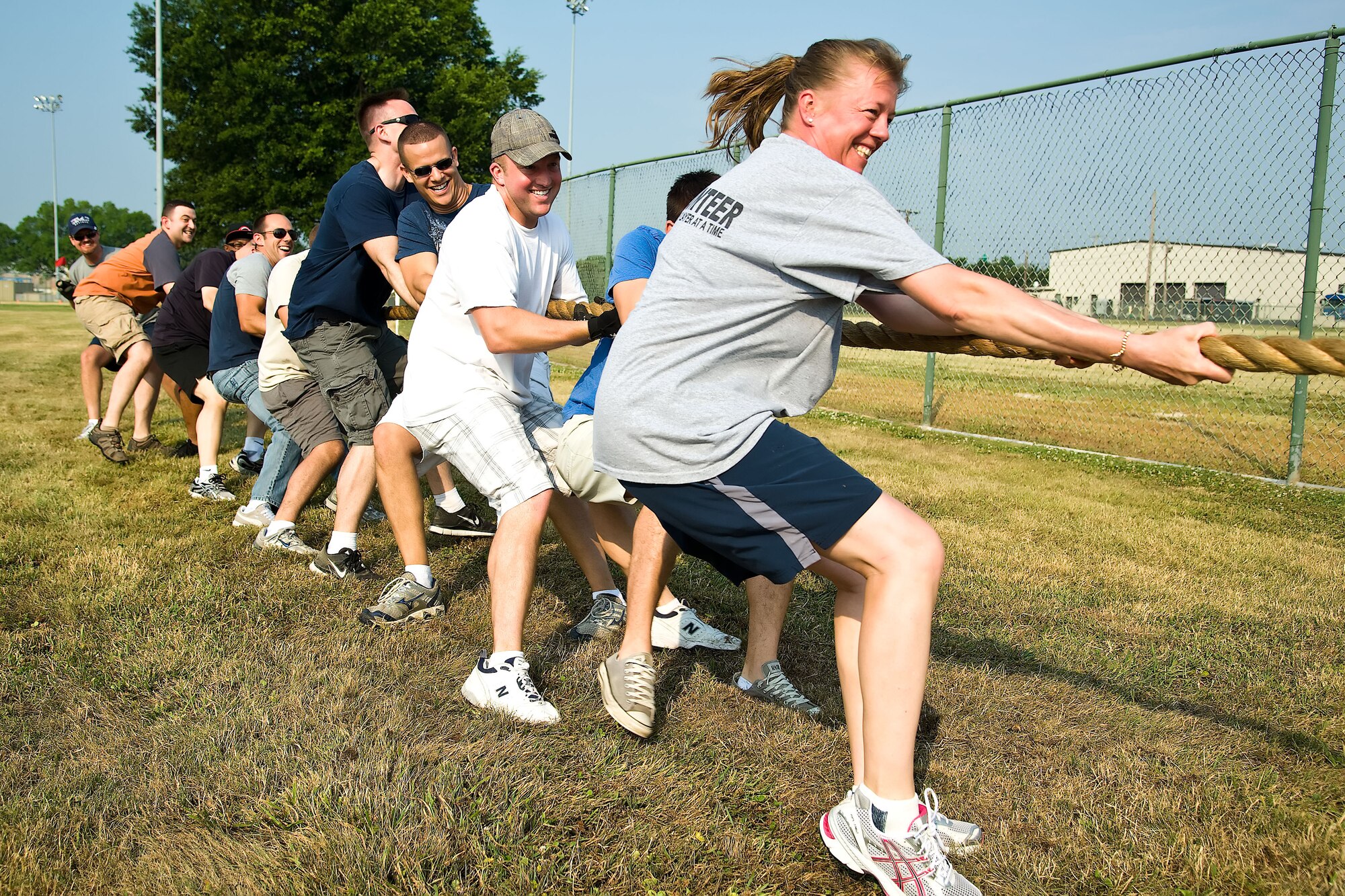 Members of the 436th Mission Support Group play tug-of-war during a group-wide sports day June 22, 2012, at Dover Air Force Base, Del. Sports day was held in conjunction with Power Reduction Day to get service members out of the office and reduce energy consumption. (U.S. Air Force photo by Airman 1st Class Samuel Taylor)