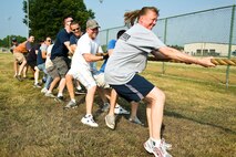 Members of the 436th Mission Support Group play tug-of-war during a group-wide sports day June 22, 2012, at Dover Air Force Base, Del. Sports day was held in conjunction with Power Reduction Day to get service members out of the office and reduce energy consumption. (U.S. Air Force photo by Airman 1st Class Samuel Taylor)