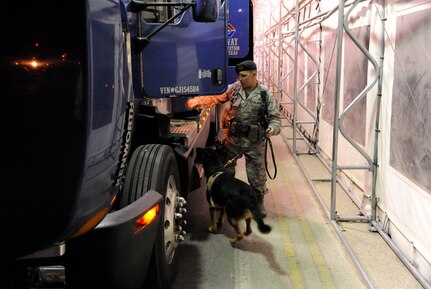 Staff Sgt. Edward Wallace, 902nd Security Forces Squadron military working dog handler, and his dog Troy, search a commercial truck at the South Gate before allowing entrance onto Joint Base San Antonio-Randolph, Texas, June 25. (U.S. Air Force Photo by Don Lindsey)