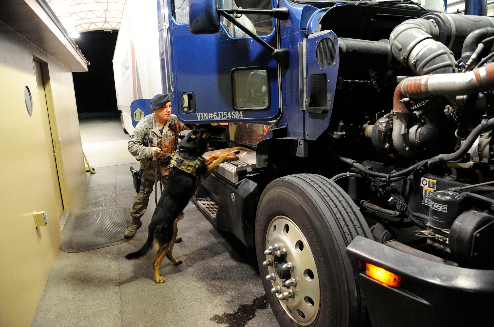 Staff Sgt. Edward Wallace, 902nd Security Forces Squadron military working dog handler, and his dog Troy, search a commercial truck at the South Gate before allowing entrance onto Joint Base San Antonio-Randolph, Texas, June 25. ( U.S. Air Force Photo by Don Lindsey)