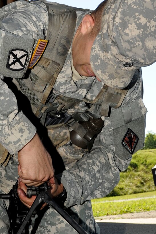 U.S. Army Staff Sgt. Jeffrey Heilman, Fort Jackson, S.C., drill sergeant, disassembles a M-249 Machine Gun during an event as part of the annual Drill Sergeant of the Year competition, hosted by Initial Military Training, U.S. Army Training and Doctrine Command, June 26, 2012, at Fort Eustis, Va. During the event six drill sergeants competed in a variety of mental and physical event for the title of Drill Sergeant of the Year. (U.S. Air Force photo by Senior Airman Wesley Farnsworth/Released)