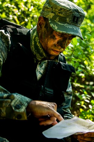 U.S. Air Force Capt. Elliot Riling, 15th Airlift Squadron, 437th Airlift Wing pilot, reads a tactical map during Survival, Evasion, Resistance and Escape Combat Survival Training at Joint Base Charleston - Weapons Station, S.C., June 21, 2012. The 437th Operations Support Squadron conducts the training which is designed for aircrews and other personnel to implement survival techniques to evade enemy forces and to signal friendly forces. (U.S. Air Force photo by Airman 1st Class George Goslin/Released)