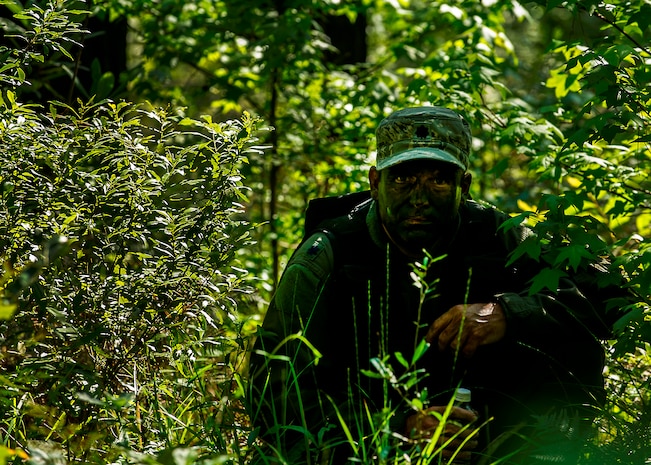 U.S. Air Force Lt. Col. Dave Owens, 15th Airlift Squadron, 437th Airlift Wing commander, waits for a signal to move while navigating terrain during Survival, Evasion, Resistance and Escape Combat Survival Training at Joint Base Charleston - Weapons Station, S.C., June 21, 2012. The 437th Operations Support Squadron conducts the training which is designed for aircrews and other personnel to implement survival techniques to evade enemy forces and to signal friendly forces. (U.S. Air Force photo by Airman 1st Class George Goslin/Released)