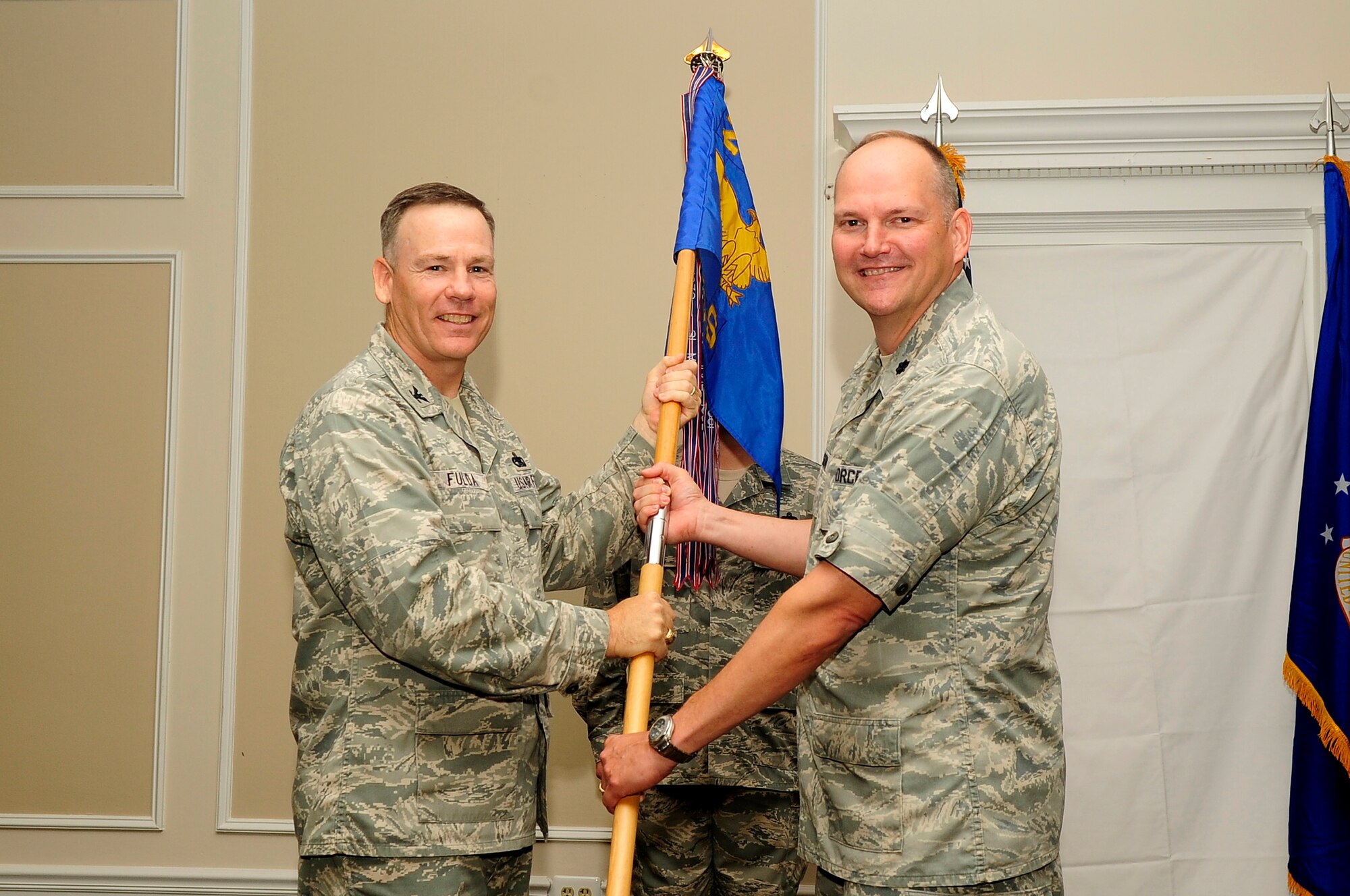 U.S. Air Force Col. Walter Fulda, 20th Mission Support Group commander, hands command of the 20th Communications Squadron over to Lt. Col. Kevin Wilson at Shaw Air Force Base, S.C., June 26, 2012. Wilson is the new 20th CS commander. Wilson was a branch chief assigned to the Air Force Information Technology efficiencies division of the Secretary of the Air Force, Pentagon, Washington, District of Columbia. (U.S. Air Force photo by Airman 1st Class Hunter Brady/Released)