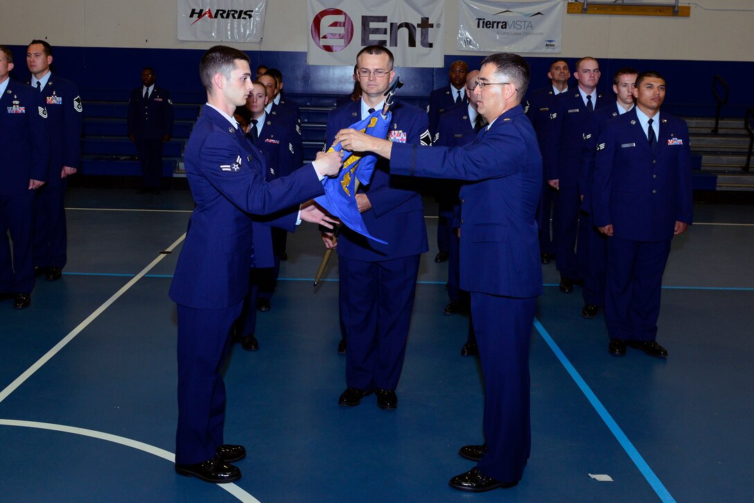 SCHRIEVER AIR FORCE BASE, Colo. - Members of the 21st Medical Group from Peterson AFB unveil a guidon during an assumption of command ceremony June 22, 2012.  The guidon will represent the newly established 21st Medical Squadron (U.S. Air Force photo/Bill Evans)