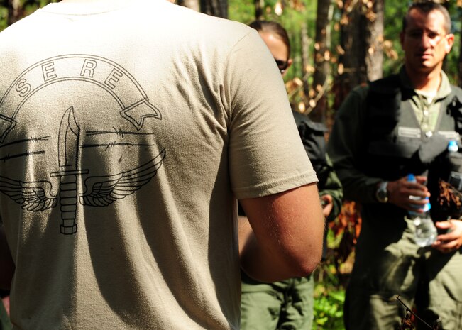 A Survive Evade Resistance and Escape specialist speaks to military members about camouflage techniques during Combat Survival Training at Joint Base Charleston - Weapons Station, S.C. June 21, 2012. The 437th Operations Support Squadron conducts the training which is designed for aircrews and other personnel to implement survival techniques to evade enemy forces and to signal friendly forces. (U.S. Air Force photo/Staff Sgt. Katie Gieratz)