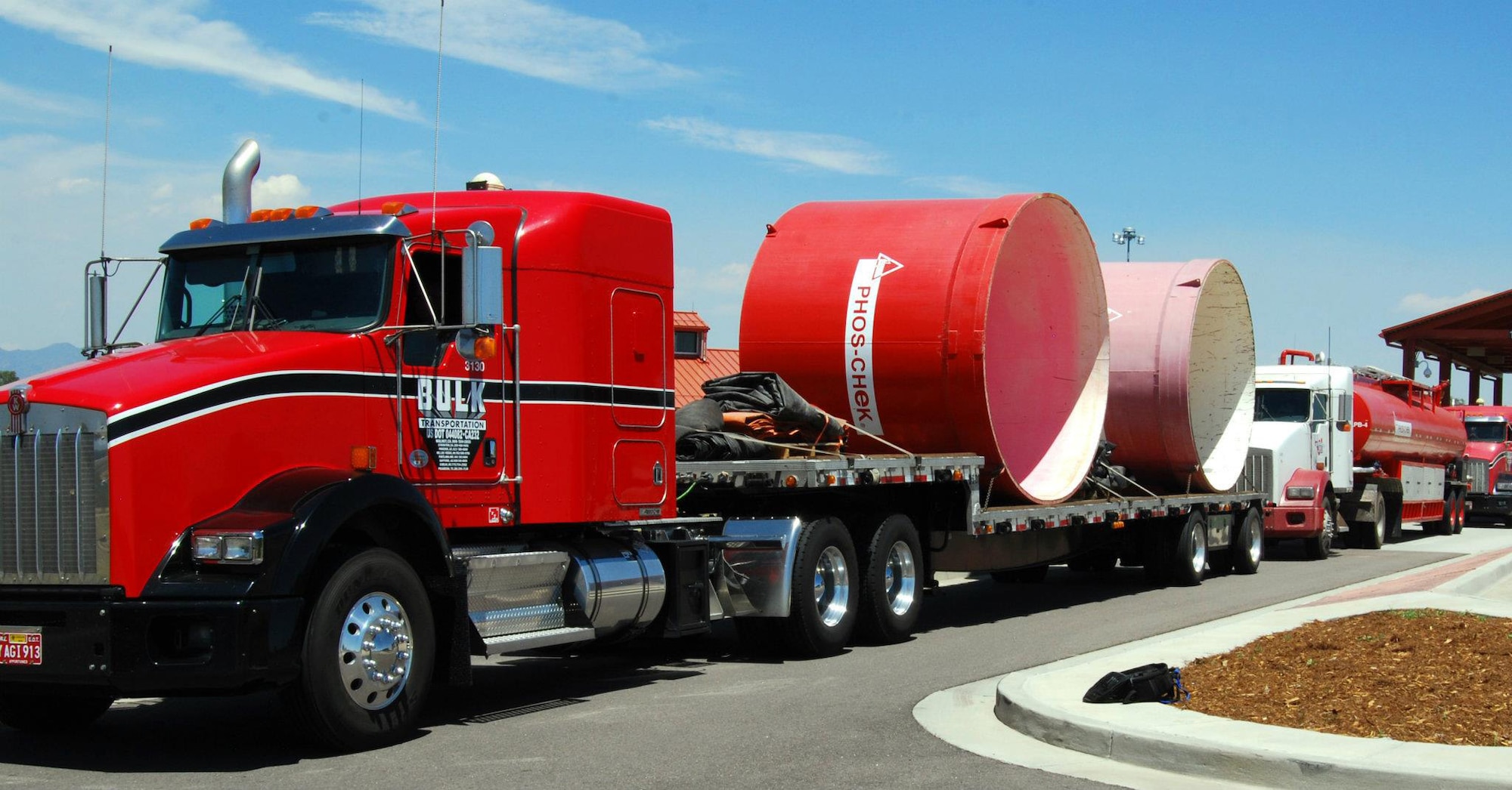 Trucks carrying fire retardant supplies enter Peterson Air Force Base, Colo., June 25, 2012. Two C-130 Hercules from the Wyoming Air National Guard's 153rd Airlift Wing joined two more C-130s from the 302nd Airlift Wing to help fight the Waldo Canyon fire near Colorado Springs and the High Park fire in northern Colorado. The retardant helps slow the fire's spread, allowing firefighters on the ground to better contain the blaze. (U.S. Air Force photo/Don Branum)