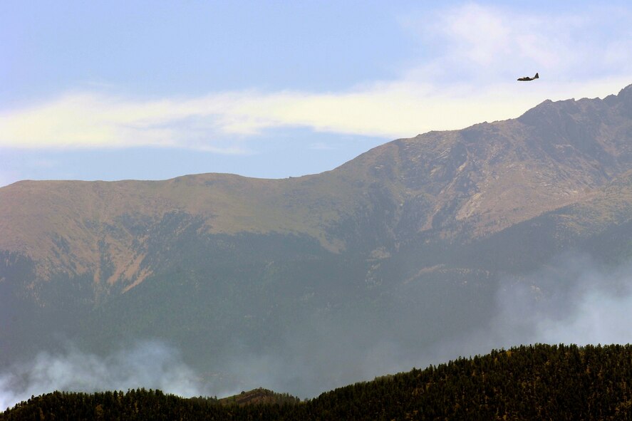 A C-130 Hercules equipped with a Modular Airborne Firefighting System heads toward the Waldo Canyon fire in the Pike National Forest near Colorado Springs, Colo., June 25, 2012. Two C-130s from the Wyoming Air National Guard's 153rd Airlift Wing joined forces with two similarly equipped C-130s from the 302nd AW at Peterson Air Force Base to help contain the fire. (U.S. Air Force photo/Mike Kaplan)