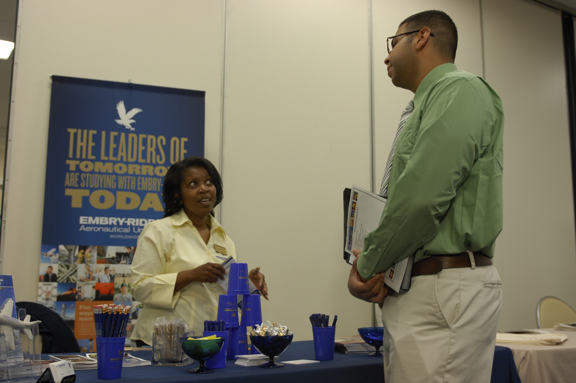 Sanette Holder, associate director of academics support for Embrey-Riddle, enlightens U.S. Air Force Staff Sgt. Elias Santiago, 20th Maintenance Group crew chief, and answers his questions about education opportunities. A total of 38 vendors set up booths at the fair. They consisted of many different universities, and corporate and government businesses. (U.S. Air Force photo by Airman 1st Class Krystal M. Jeffers/ Released)