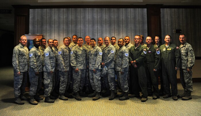 Col. Erik Hansen (left), 437th Airlift Wing commander and Chief Master Sgt. Larry Williams (right), 437th Airlift Wing command chief, welcome the 437th AW's new technical sergeants at a release party at Joint Base Charleston- Air Base June 21. (U.S. Air Force photo/Airman 1st Class Ashlee Galloway)